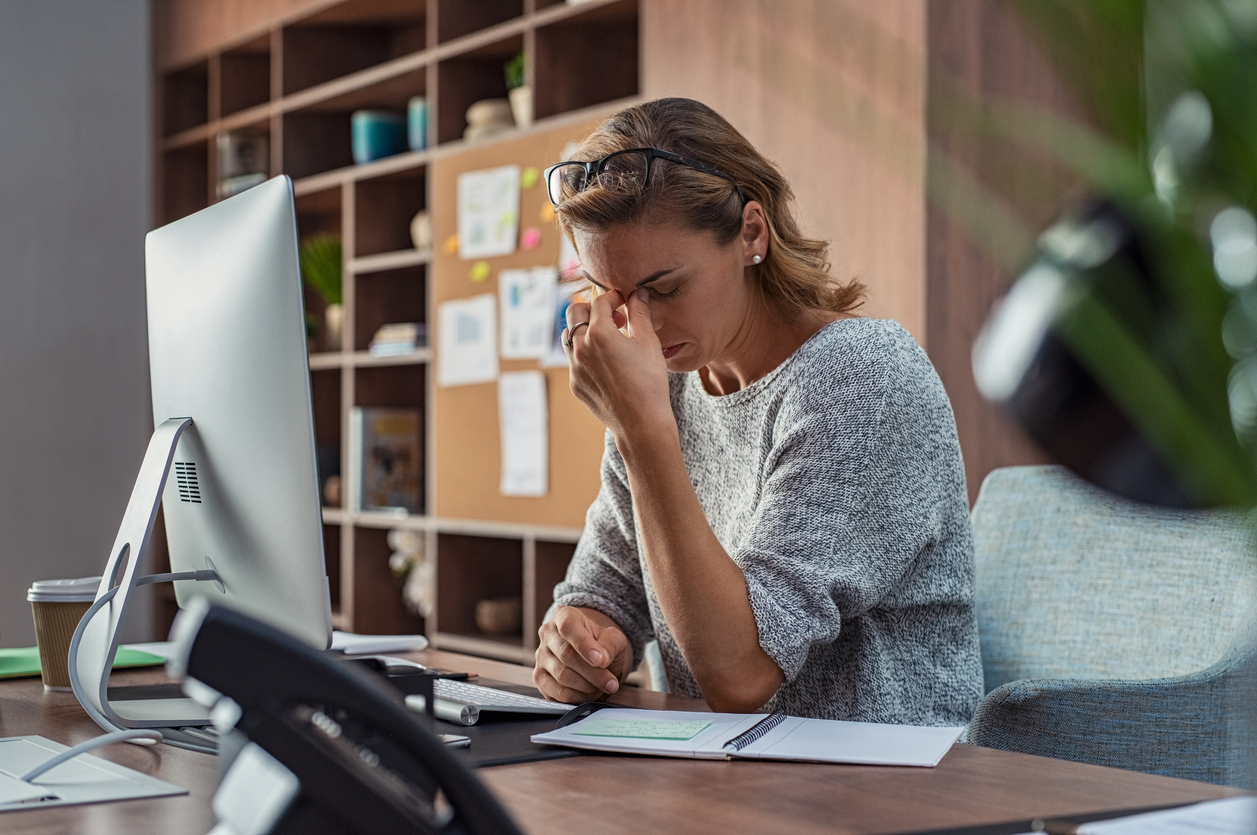 Stressed woman sitting at desk